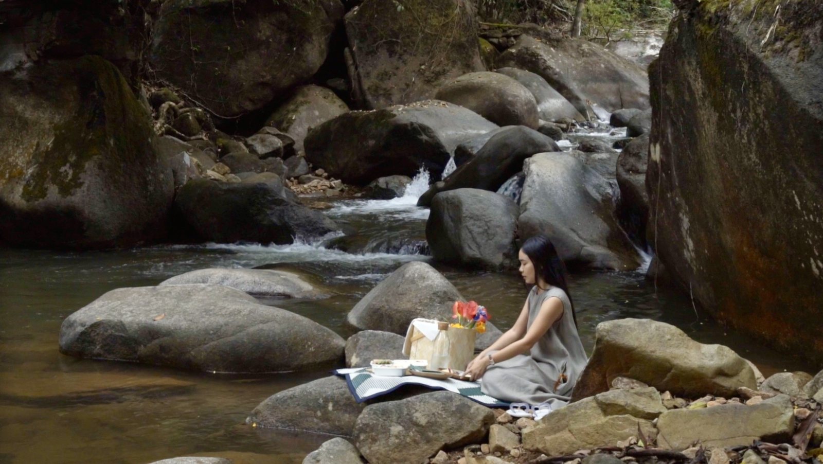 The Motifs Eco Hotel — a guest by a forest stream