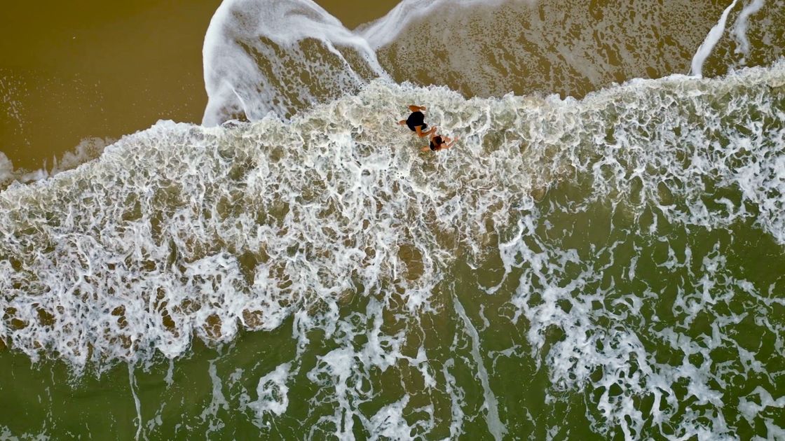 Aerial over the turquoise shallows off the resort