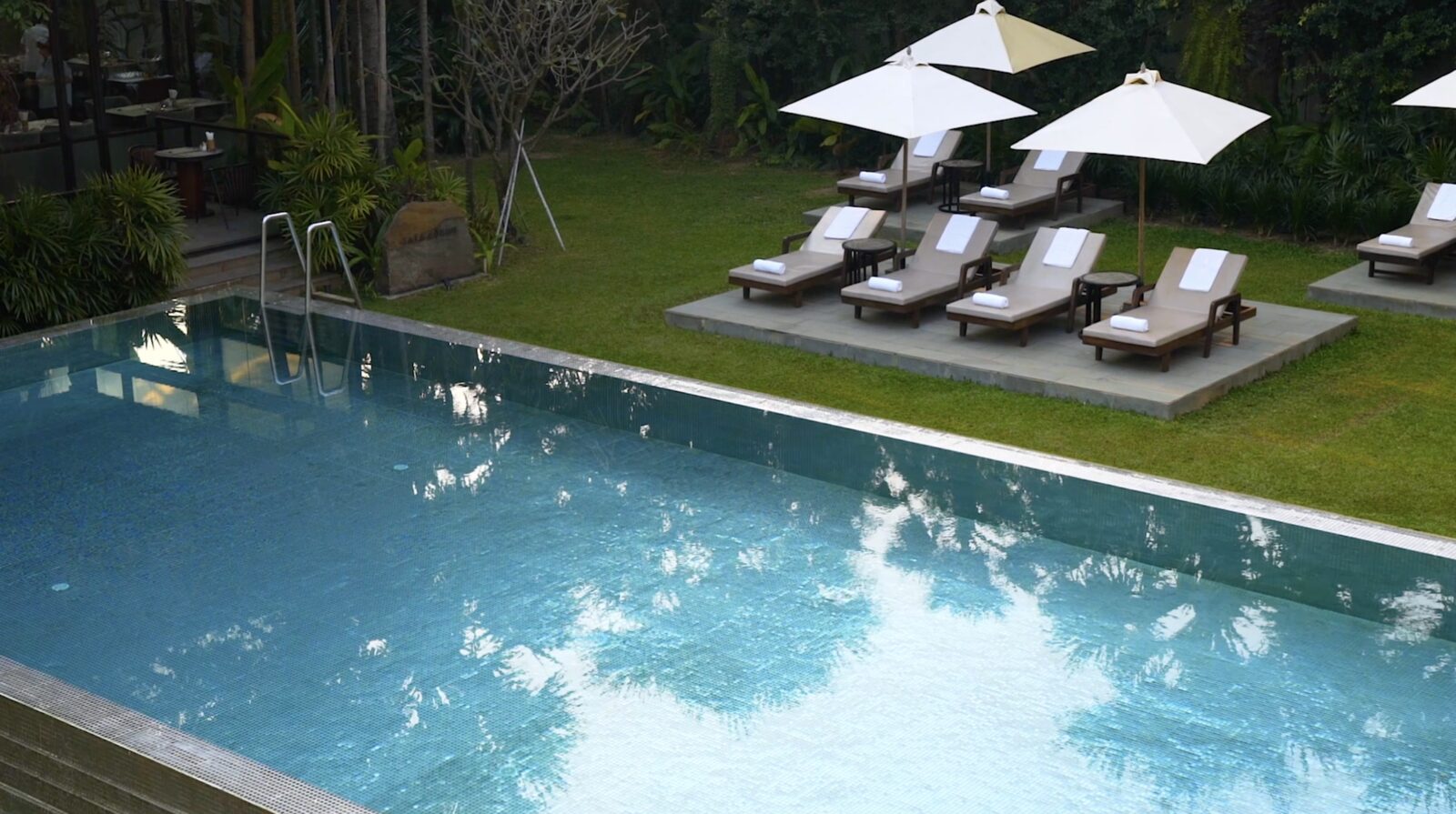 The pool at Shintana Saya under white umbrellas, Siem Reap