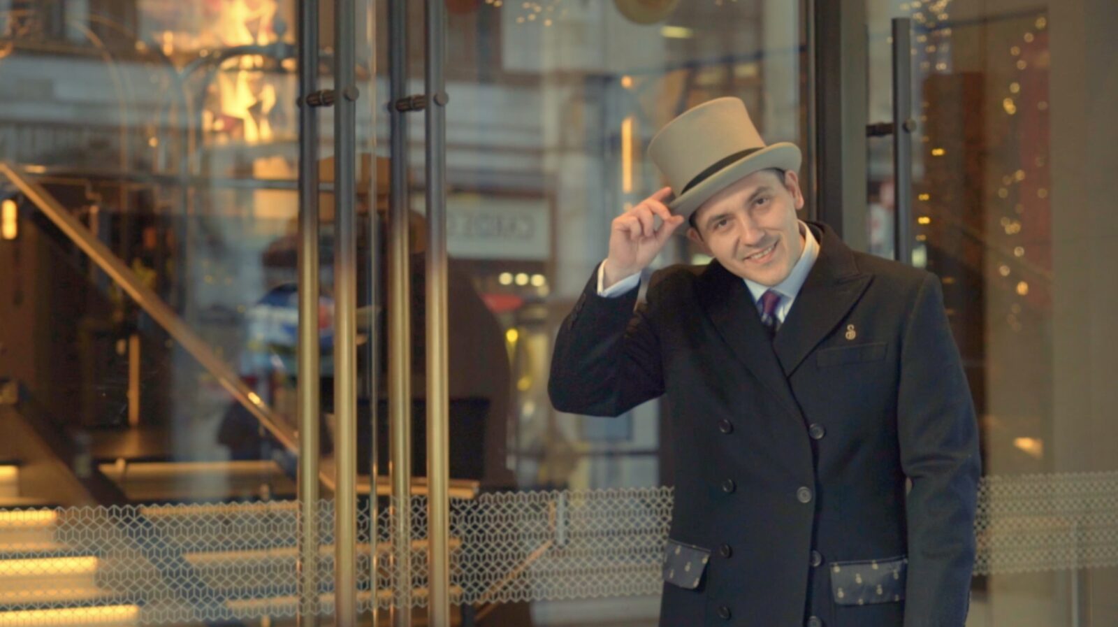 The Strand Palace doorman tips his hat at the entrance