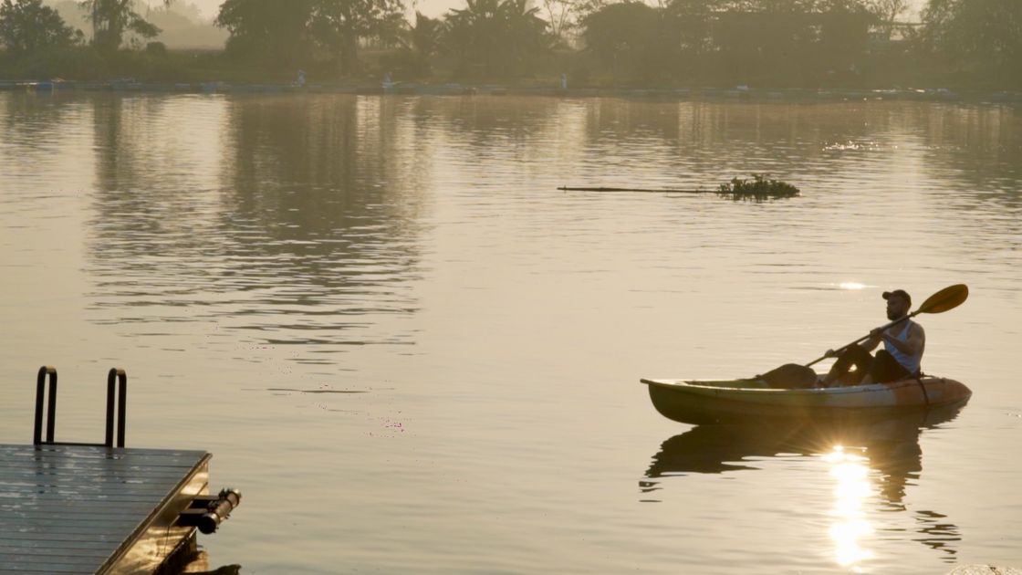 A kayak on the misty river at dawn