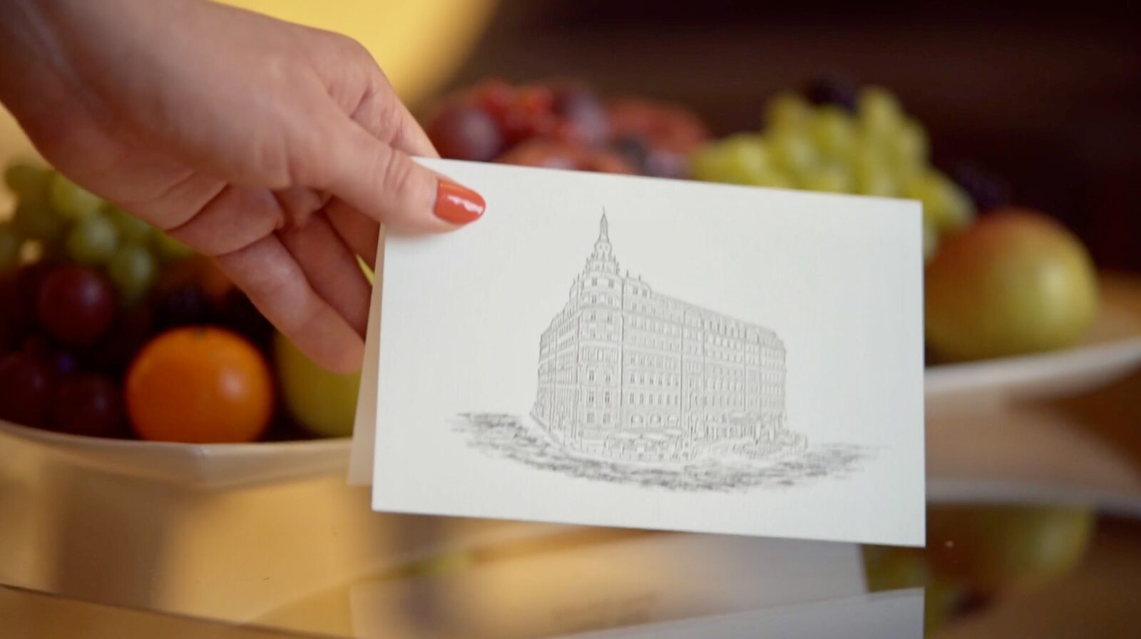 A hotel welcome card placed in a guest's hand — the direct relationship
