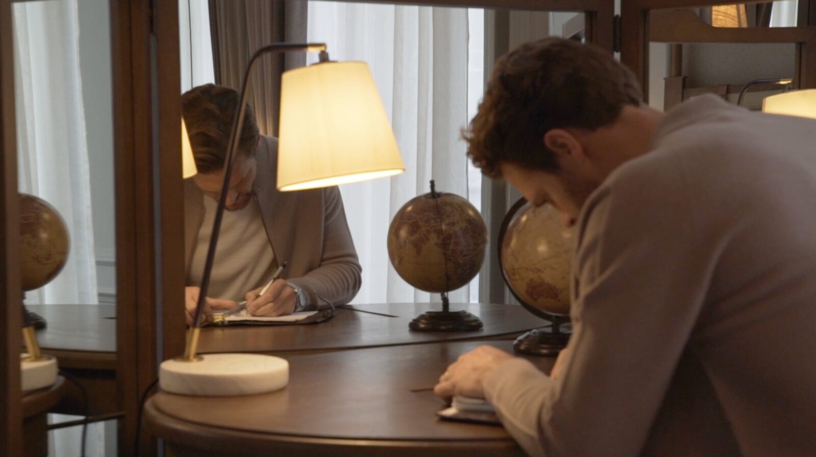 Writing desk, globes and lamplight